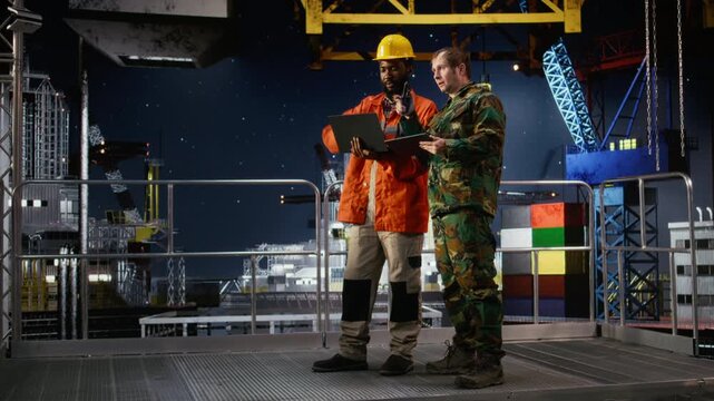 Naval officer and engineer using walkie talkie on oil rig vessel to manage threat response and border security operations, ensuring safe offshore drilling and protection of assets. Camera A.