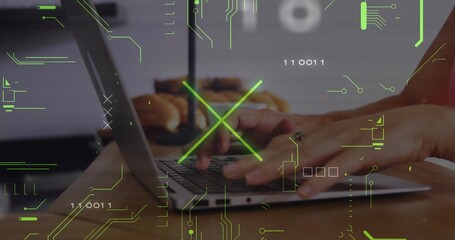 Typing hands pressing keys on clamshell laptop in home kitchen, with ring, pastries, green HUD