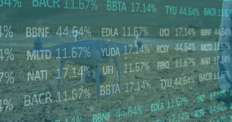 Hovering consumer drone showing teal data overlay over field, operator in blue jeans light jacket