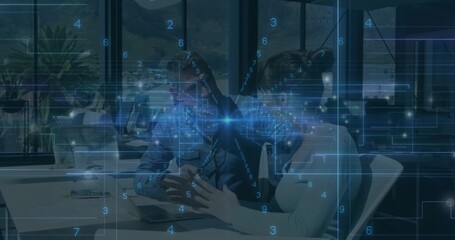 Collaborating coworkers in business-casual clothing leaning over laptop in office with HUD overlay