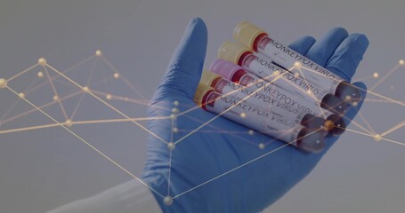Presenting gloved hand holding five MONKEYPOX VIRUS tubes at clinical lab, gold network overlay
