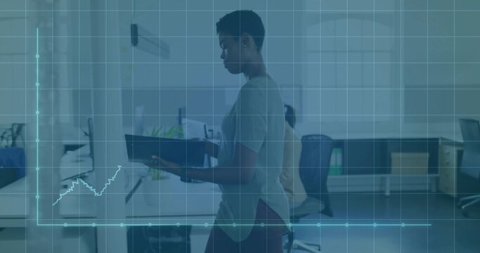 Walking woman holding dark binder in casual attire crossing open-plan office with data overlay