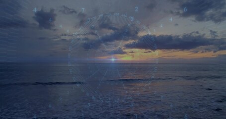 Glowing sun with centered HUD overlay reflecting on ocean at sunset, showing right coastline © vectorfusionart
