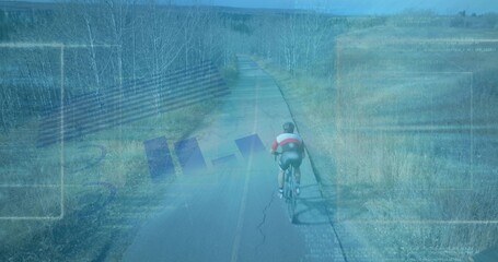Pedaling teenage cyclist riding on rural paved road with road bicycle, helmet, jersey, copy space © vectorfusionart