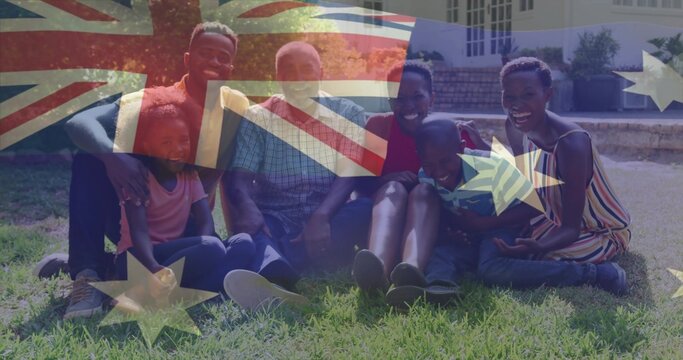 Sitting family chatting on grass lawn by house, wearing sneakers, short-sleeve shirts, flag overlay - Powered by Adobe