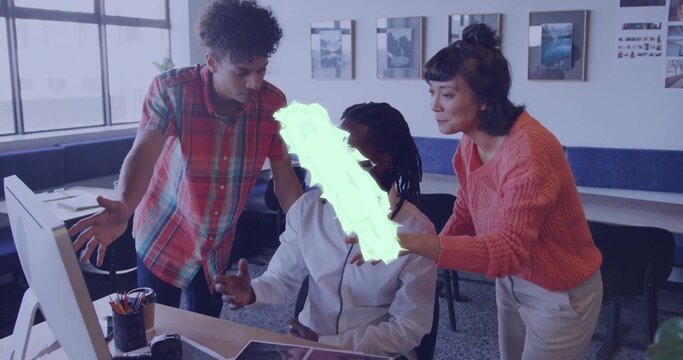 Working coworkers leaning, pointing, typing at open-plan desk, wearing coral sweater, with monitor - Powered by Adobe