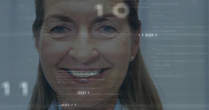 Smiling senior woman in studio showing braces, in light blue shirt with stud earrings, data overlay