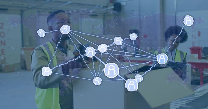 Packing workers wearing hi-vis safety vests placing items in box at warehouse, showing data overlay - Powered by Adobe