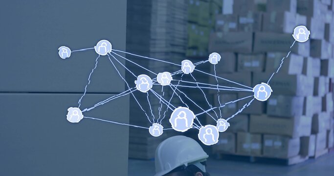 Displaying AR overlay above boxes on pallets in warehouse, worker wearing white hard hat