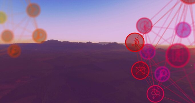 Stretching mountain ridge and valley running along horizon at sunrise, showing neon network overlay