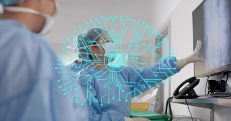 Pointing doctor in gown and mask reviewing monitor with AI overlay, green tray, operating room