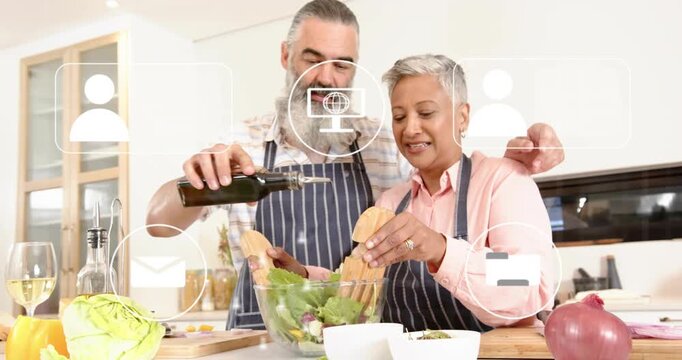 Man pouring oil and woman tossing salad at kitchen island, animated UI icons guiding salad prep