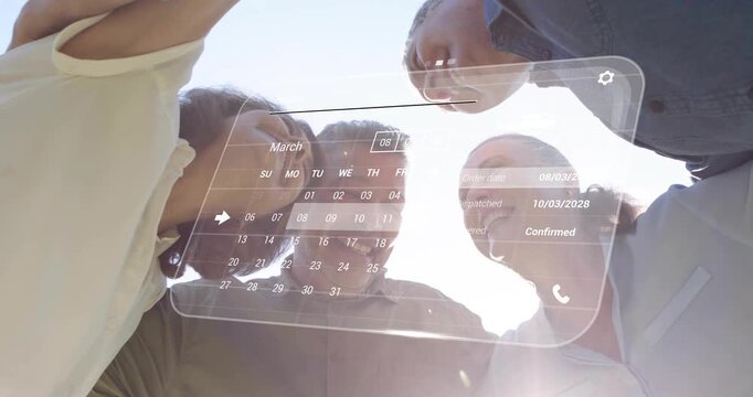 Four adults leaning over camera, AR calendar appearing and updating while confirming March orders