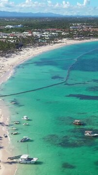 Caribbean coastline with resorts, palm trees and tropical sea. Travel destinations. Dominican Republic. Aerial view