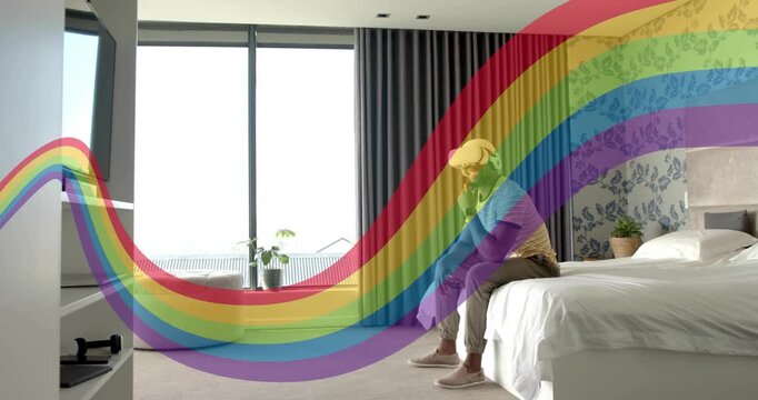Man with VR headset adjusting, reaching bedside while rainbow arcing over him starting tech demo