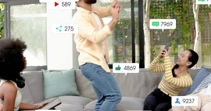 Bearded man in VR headset rising, gesturing on sofa, multiplying social badges around him for likes