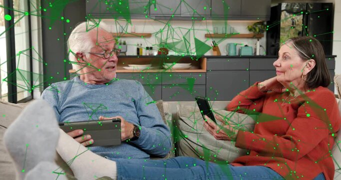 Senior man linking after tablet tap partner looking up laughing green overlay connecting to couple