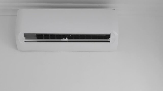 Flat air conditioner split system on white wall in room. closeup