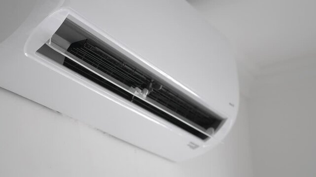 Flat air conditioner split system on white wall in room. closeup