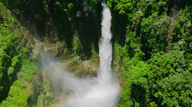 Tropical waterfalls surrounded by forest. Hikong Bente Falls in Lake Sebu. Mindanao, Philippines. Slow motion.