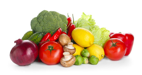 Pile of different fresh raw vegetables and lemons isolated on white