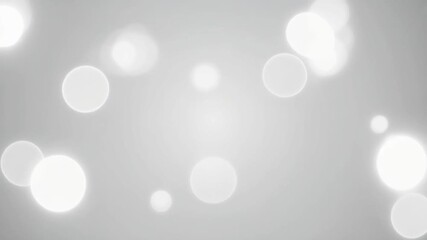 Soft focus white bokeh lights illuminate a gentle grey gradient background, creating an elegant and ethereal visual display perfect for modern design and celebratory themes - Powered by Adobe
