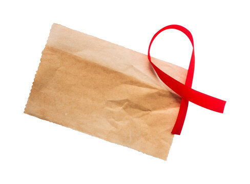 old paper with red ribbon isolated on white background