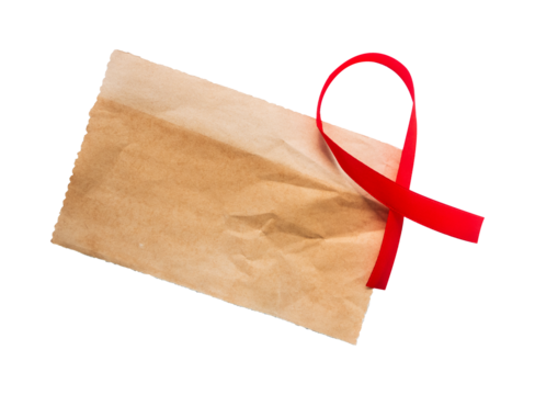 old paper with red ribbon isolated on white background