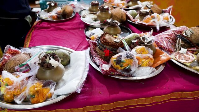 traditional hindu pooja thali with coconut flowers and ritual items on plate for sale at temple