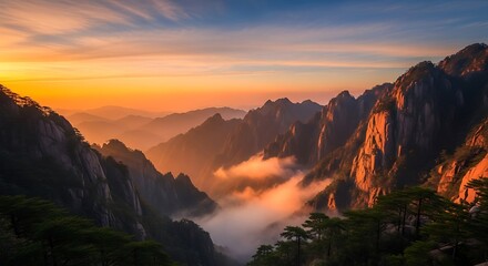 Fototapeta premium Golden hour bathes the majestic huangshan mountains in ethereal light and mist