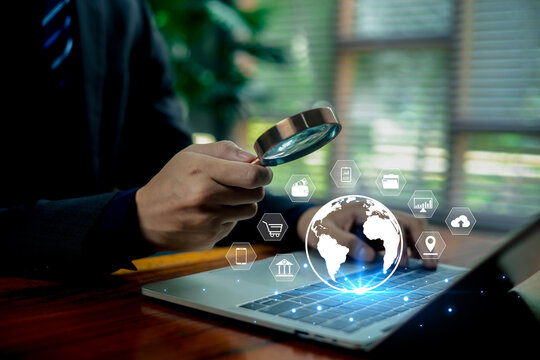 Business professional analyzing digital data with a magnifying glass over a laptop, surrounded by glowing global technology icons representing cybersecurity, analytics, and modern online services.