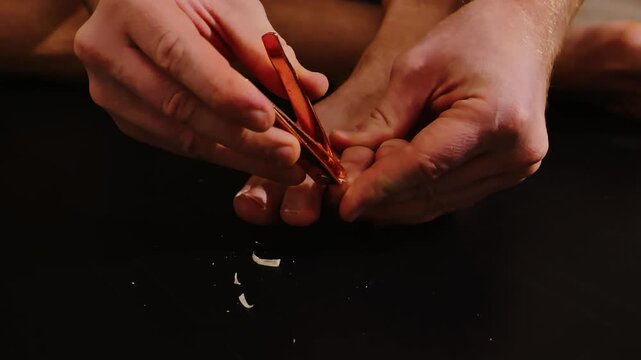 Detailed shot of foot hygiene ritual with nail clippings and soft shadows