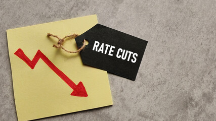 Rate Cuts and Economic Decline: Black Price Tag with Text Over Downward Trend Arrow Graph...