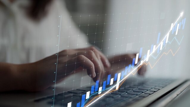 A person focuses on the laptop, analyzing stock market trends through digital graphs and data, capturing the essence of modern finance and investment strategies. Copula