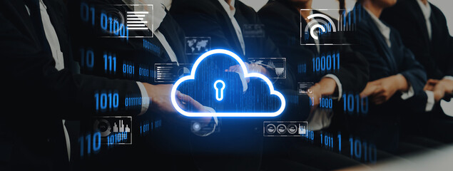 A group of business professionals in suits discuss technology and cloud security concepts surrounded by digital data visualizations in a modern conference setting. Trope
