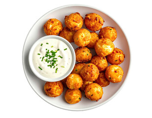 Crispy golden-brown fried food balls and creamy sauce, served on a white plate