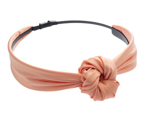 Peach-colored fabric headband with a large knotted design, resting on a black base