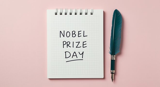 Nobel Prize Day written on a notepad with a feather pen on pink background writing notebook