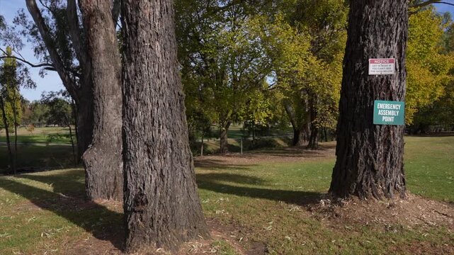 Wide shot Comical warning sign about flood levels around Morley creeks river in Gundagai, New South Wales, Australia