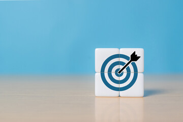 Business goals concept. Strategy and goals achievement. Hand puts dice with goals, target icon on grey background. Business planning, common goals, business vision, planning and strategies