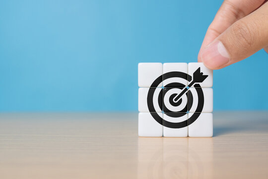 Goal and planning concept, Hand holding dice with target aiming dart board, Business achievement objective goal and project progress growth value processing marketing financial, Reach target