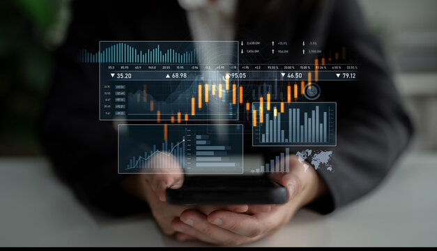 A focused businessperson interacts with a mobile device displaying financial data and graphs, symbolizing the integration of technology in trading and market analysis. Scalp