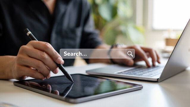 Digital artist creating stunning artwork on tablet alongside laptop, perfect for showcasing technology and creative workflows in the modern workspace