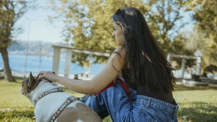 Woman Petting Dog in Park by the Water