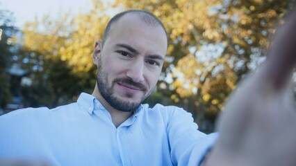 Man Taking Selfie in Autumn Park Setting