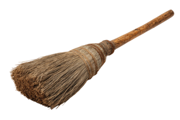 Old, worn broom with a wooden handle on black background