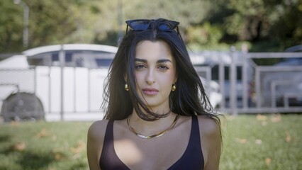 Confident woman with long hair in outdoor setting