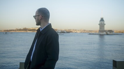 Man in glasses by the waterfront with lighthouse view