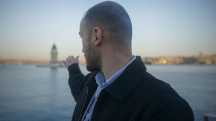 Man Pointing Towards Iconic Lighthouse by the Sea