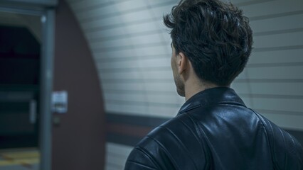 Man in Leather Jacket Waiting at Subway Station